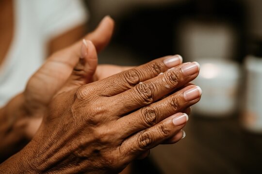 Hand of an elderly woman, showing signs of aging.