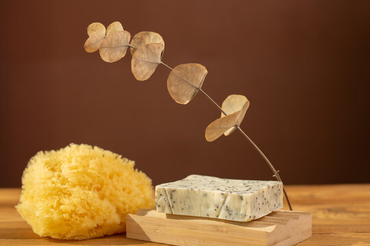 Natural herbal soap with scrub. Handmade soap bars on a wooden background. Space for text. 