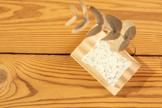 Natural herbal soap with scrub. Handmade soap bars on a wooden background. Space for text. 