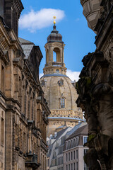Naklejka premium Frauenkirche dome and bell tower framed between historic baroque facades in Dresden Germany