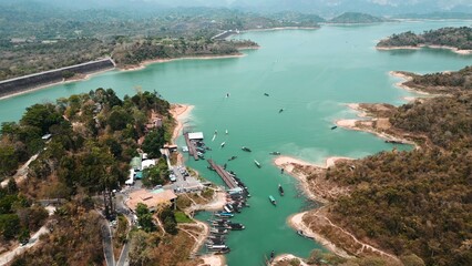 Fototapeta premium Khao sok lake aerial view with dam, lush forest and longtail boats