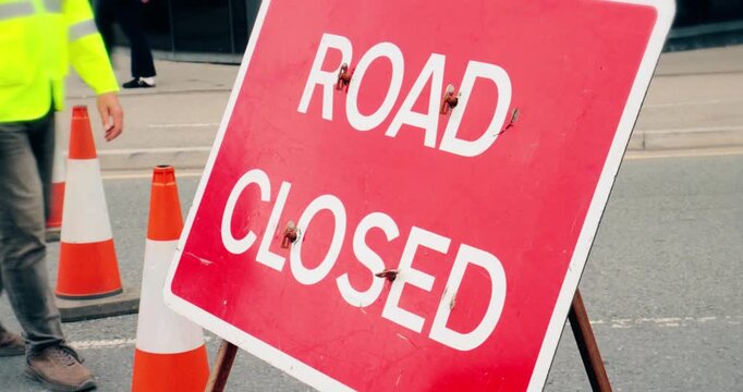 Road closed street sign &ndash; Emergency services diverted traffic highway road sign in the event of a roadblock. Travel safety on closed street. High visibility red signage marking temporary closure.