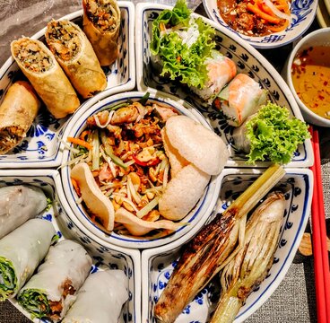 Overhead view of a platter of assorted Authentic Vietnamese Rice Paper spring Rolls with crispy pork, lettuce and herbs