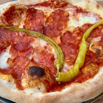 Full frame close-up of a spicy Italian salami and pepper pizza