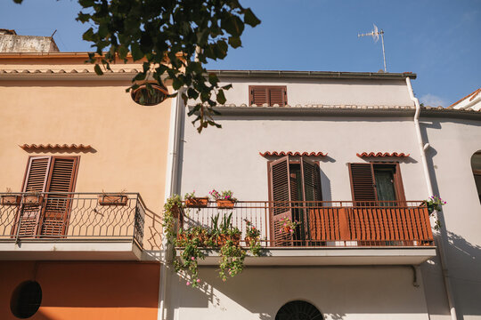Low angle view of traditional Italian houses with balconies and wooden  window shutters  on the Amalfi Coast, Cetara, Salerno, Campania, Italy