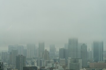 Tokyo Skyline Emerging Through Dense Fog After Heavy Rain, Rare Weather Conditions Creating a Dramatic Cityscape in Japan © minortica7