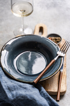 Overhead view of a rustic place setting on a wooden chopping board
