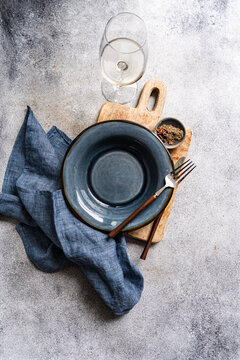 Overhead view of a rustic place setting on a wooden chopping board