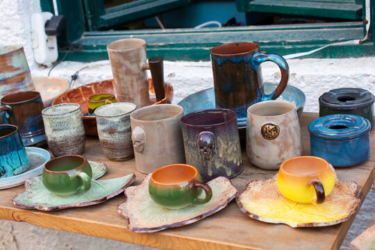 Assorted multi coloured Handcrafted Ceramics Displayed on Rustic Wooden Tab