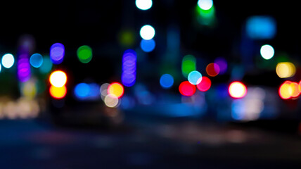 Blurred night city street lights with colorful bokeh circles and dark abstract background © josh