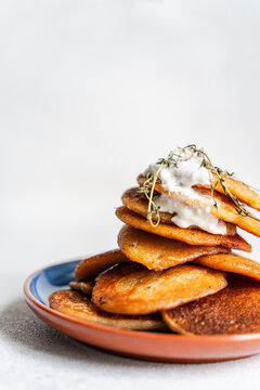 Close-up of a stack of Potato pancakes (draniki) with natural yogurt and fresh thyme