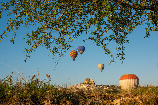 Colourful hot air balloons flying over valley, Cappadocia, Goreme, Anatolia, Turkey