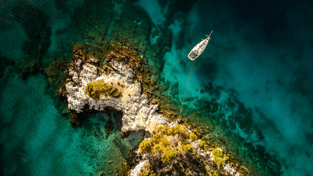 Aerial view of a yacht moored off an island in the Aegean Sea, Sporades islands, Greece