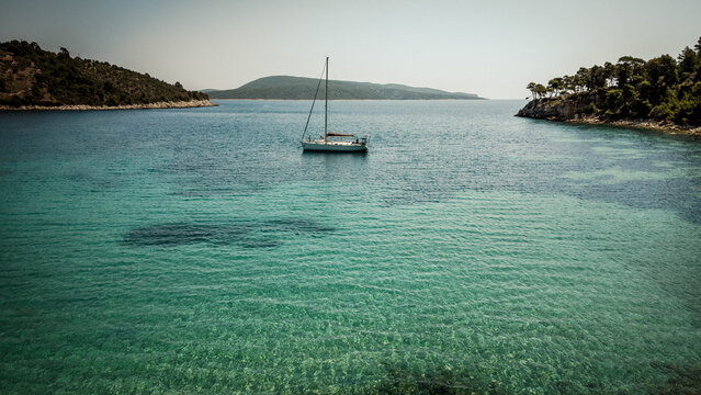 Yacht anchored off an island in the Aegean Sea, Sporades islands, Greece