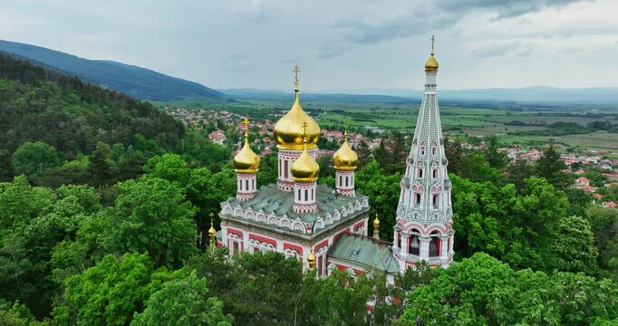 Shipka Memorial Russian Church, bulgarian mountains and town of Shipka, Bulgaria, aerial drone landscape view

