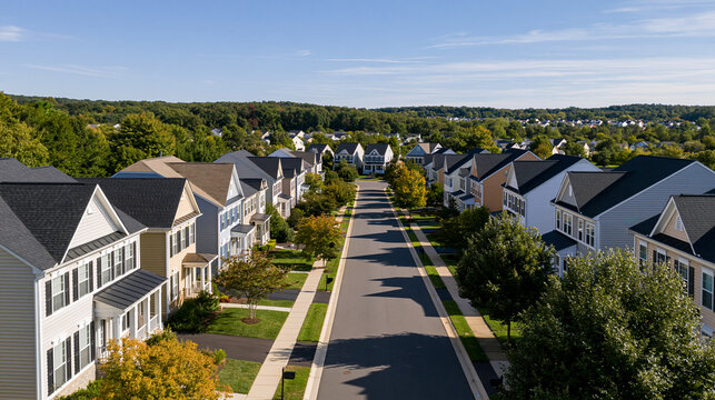 Aerial view of an upper middle class neighborhood street with luxury single-family homes and colorful siding in Maryland USA, with copy space