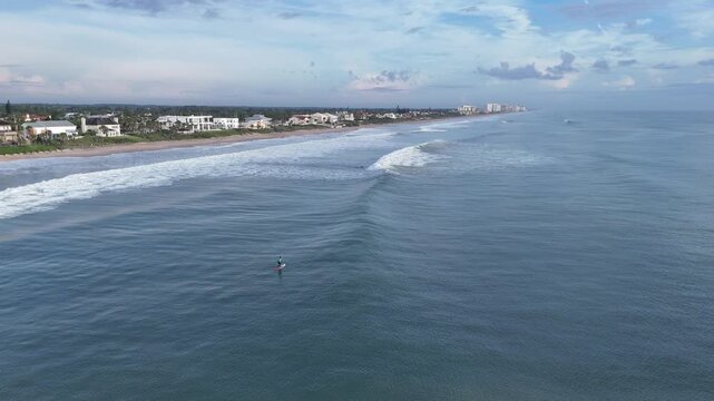 Stand up paddleboarder on a beautiful morning at Ormond Beach in Volusia County, Florida. 