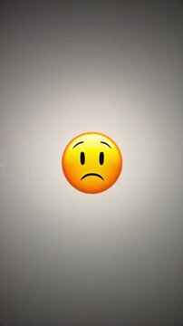 Emoji rotating vertical view with sly smile, small face and empty gray background for expression morphing, sarcasm cue, social reaction, user response, mood transition, and digital communication media