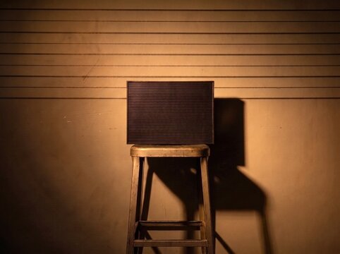Blank letter board on stool against police lineup wall