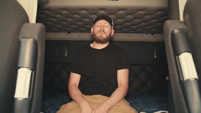 Stressed truck driver experiencing headache in sleeper cab