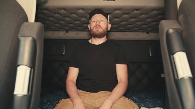 Truck driver resting in semi truck sleeper berth
