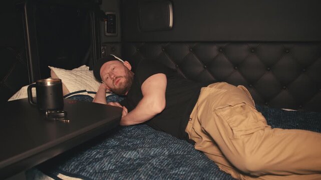 Tired truck driver falling asleep inside sleeper cab