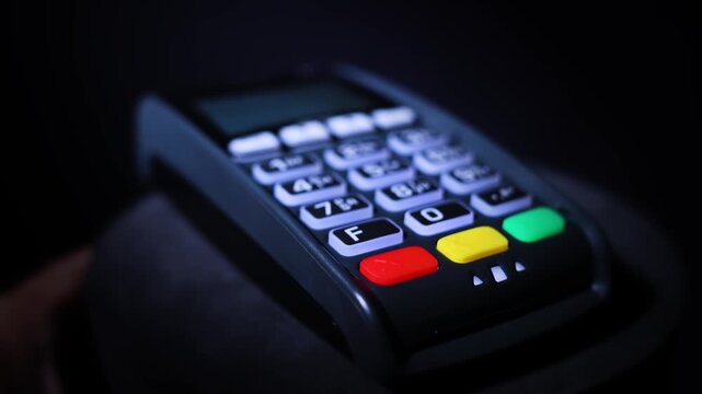 Hand Pressing Button On Credit Card Payment Terminal 