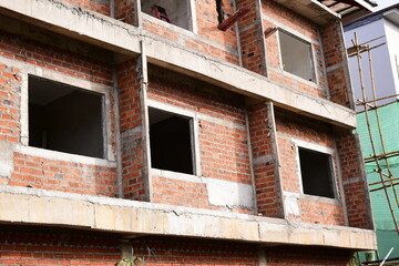 Obraz premium exterior view of brick house under construction with concrete structure