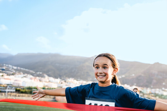 Sport child running to finish line during marathon race - Kid runner winning at sprint competition