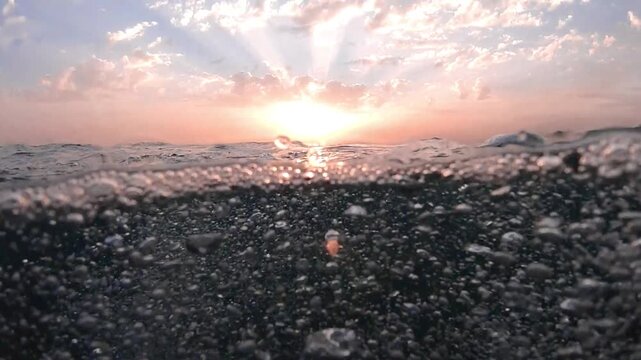 Sunbeams and bubbles underwater. Underwater slow motion bubbles moving to surface in turquoise crystal clear sea. air bubbles underwater bubbles coming up to the surface blue water ocean scenery. Pool