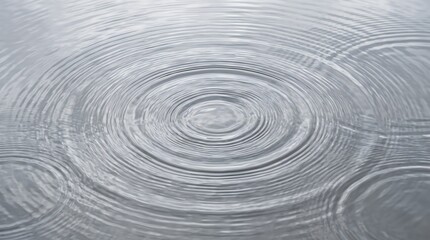 Fototapeta premium water ripples spreading in concentric circles on a grey surface minimalist calm backdrop