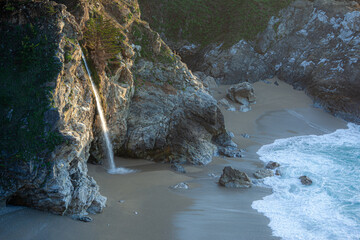 McWay Falls cascades onto the beach at Julia Pfeiffer Burns State Park, Big Sur, California, USA. This iconic waterfall flows directly into the Pacific Ocean. © Zenstratus