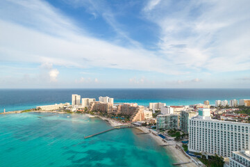 Fototapeta premium Aerial panoramic view of Cancun beach and city hotel zone in Mexico. Caribbean coast landscape of Mexican resort with beach Playa Caracol and Kukulcan road. Riviera Maya in Quintana roo region on