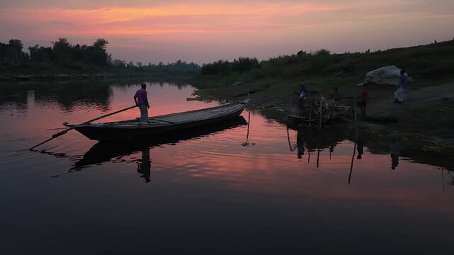 Serene river sunset with lone boatman rowing peaceful water reflection rural landscape tranquil