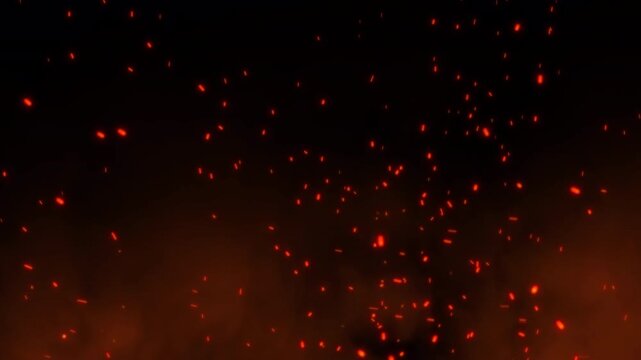 Hot burning ashes motion mixed with an orange smoke fire spark effect. Bright glowing bonfire particles rising fast in a fiery sky background