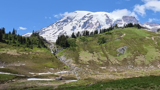 Snowy Mountain Peak with Green Slopes and Stream in Washington