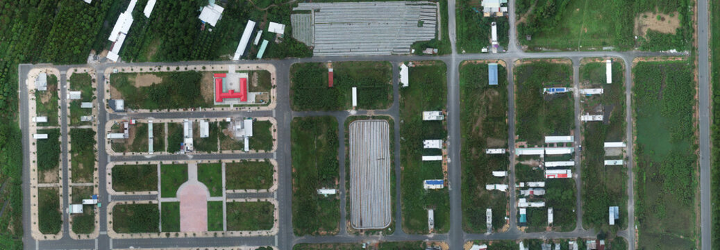 Aerial view of an unfinished urban residential development with empty road infrastructure.