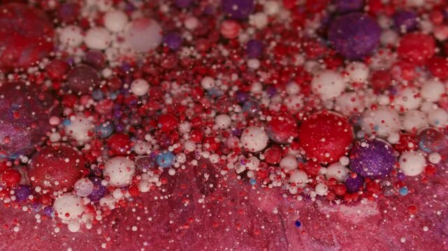 Droplets texture. Ink oil fluid. Defocused red blue purple colorful water bubbles floating on abstract acrylic creative art background.