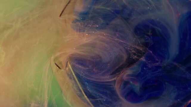 Ink haze steam. Glitter vapor. Defocused blue pink green colorful sparkling wet mix pigment filling broken glass on underwater abstract background.