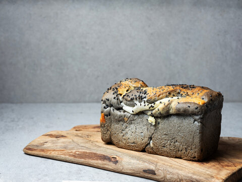 Squid ink bread on a cutting board
