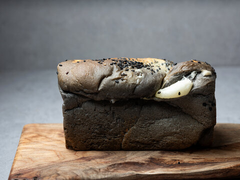Squid ink bread on a cutting board