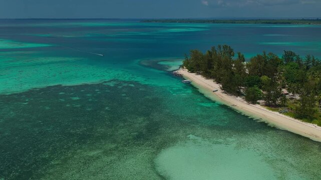 Slow aerial drone approach towards the scenic tip of Candaraman Island in Balabac, Palawan, Philippines, featuring white sand and crystal-clear turquoise water.