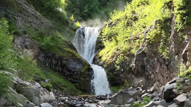 Waterfall cascading down rocky cliff in Washington state forest