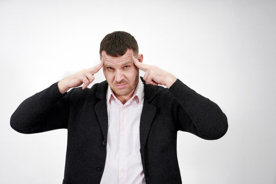 Man suffering from strong headache, massaging temples, feeling stressed