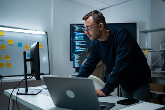 software developer talk strategy plan to executive write prompt AI bot IT app program data analytics in tech startup office.Projected visuals and glowing code on screen.AI chatbot technology concept