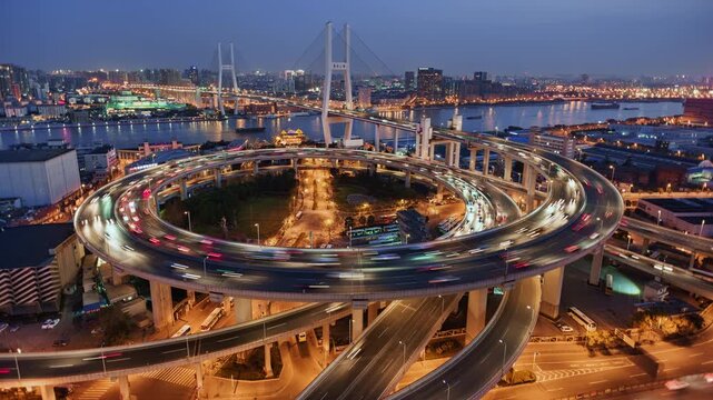 Cityscape day to night transition time lapse of Nanpu bridge illuminated at night with, with evening time rush hour commuters