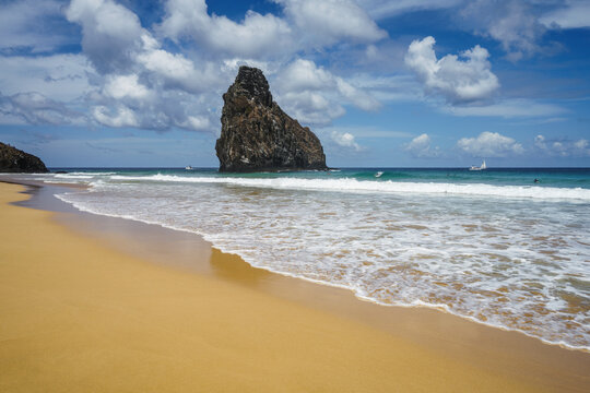 Empty beach with the Dois Irmaos rocks and turquoise sea, Fernando de Noronha, Pernambuco, Brazil