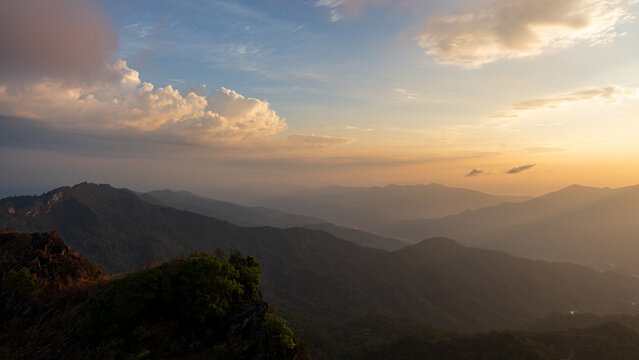 beautiful sunset over mountain range in tropical rainforest on countryside landscape