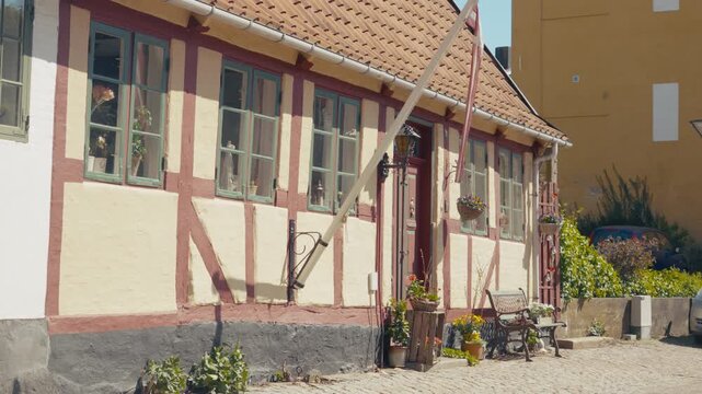Pastel half-timbered houses line a quiet street in the historic old town of Haderslev, southern Denmark.