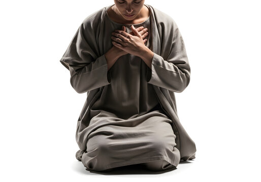 Man kneeling in prayer, hands on heart, gray robe, white background